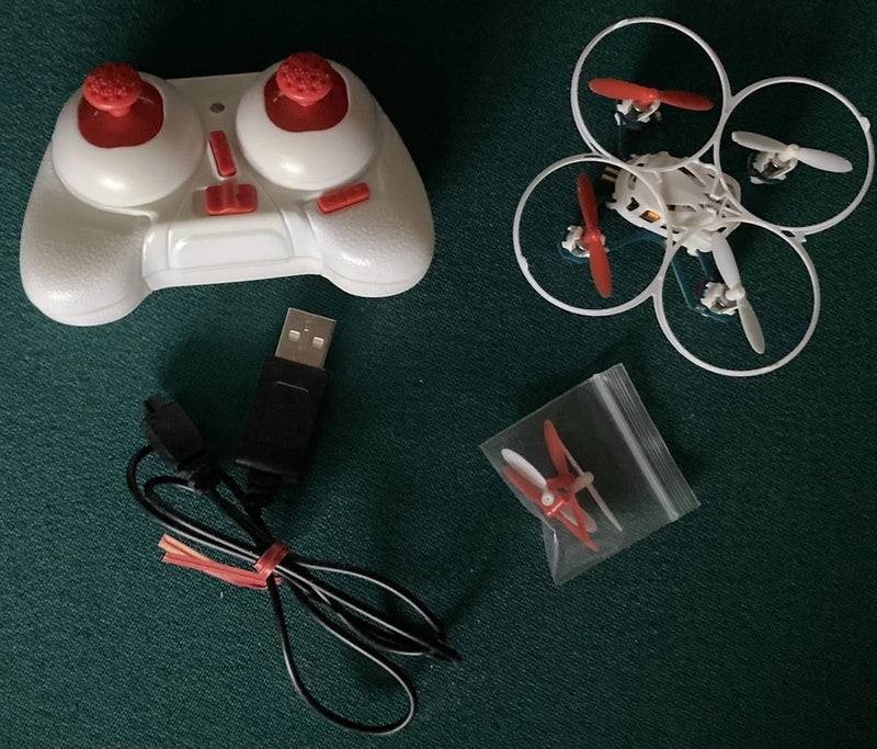 Mosquito drone quadcopter with white body, red prop guards, USB charger cables and spare blades