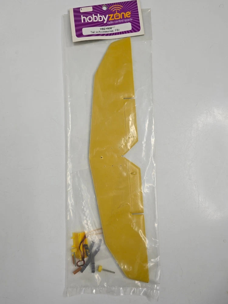 Yellow airplane tail section with small accessories, sealed in clear plastic bag