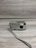 HP digital camera for parts with wrist strap, front view, silver-gray body
