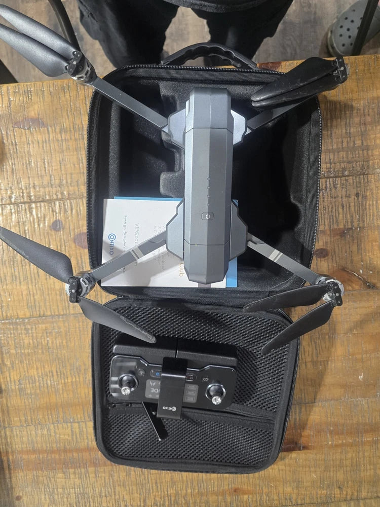 Gray quadcopter drone with controller in hard carrying case