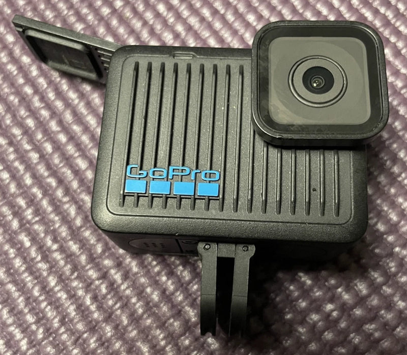 GoPro HERO action camera (black) front with lens and mount tab, for parts only