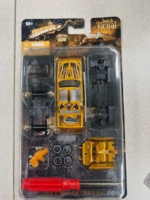 Gold lowrider car model kit in blister pack with parts and wheels