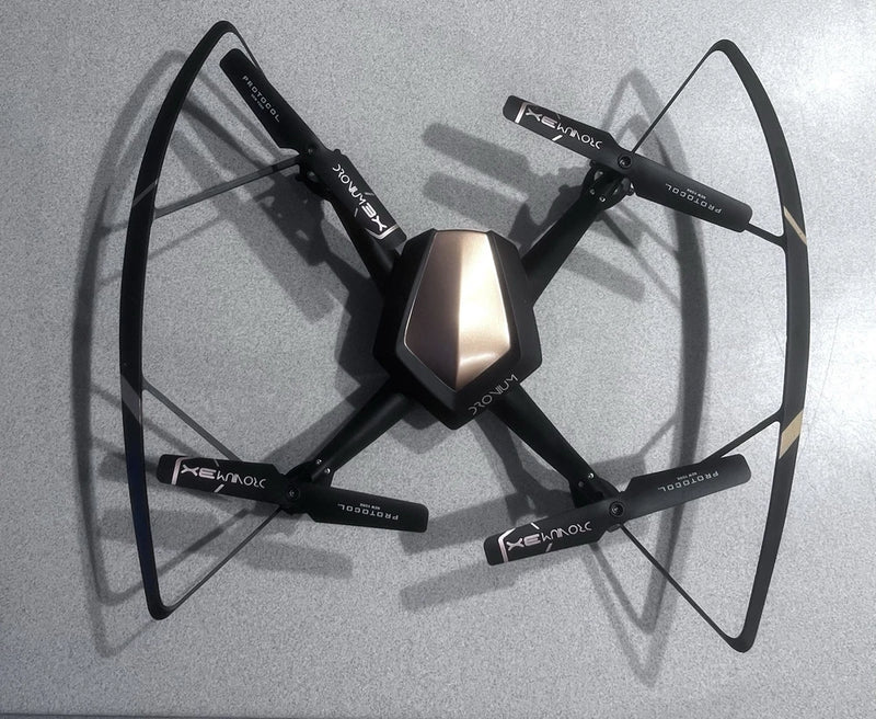Black FPV quadcopter with four propellers and front camera module