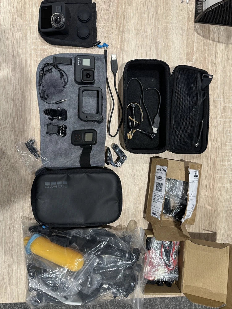 GoPro camera bundle with hard cases, mounts, cables, and accessories pouch