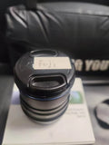 Black camera lens with front cap and Fuji label