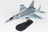 MiG-29G model airplane on black stand, light blue/gray camo with Polish markings