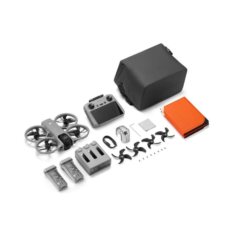 DJI drone kit with remote, batteries, spare propellers, case, and orange accessory card