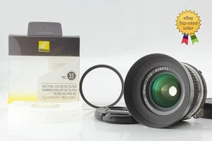 Black wide-angle camera lens with green glass, front element and mounting ring