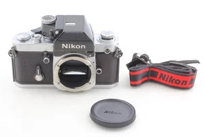 Nikon 35mm SLR film camera body with DP-11 finder, neck strap, and lens cap