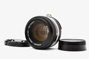 Black Nikon Ai-s Nikkor 50mm f/1.4 manual focus lens with front element