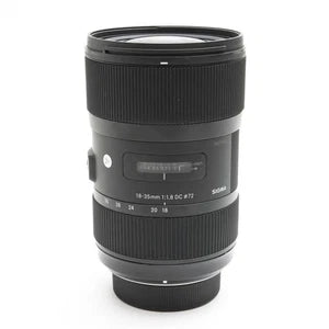 Black camera lens with textured focus ring and front filter threads