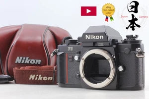 Black Nikon F3 35mm SLR film camera body with lens mount and strap