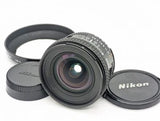 Nikon AF Nikkor 20mm f/2.8 wide-angle prime camera lens with front and rear caps